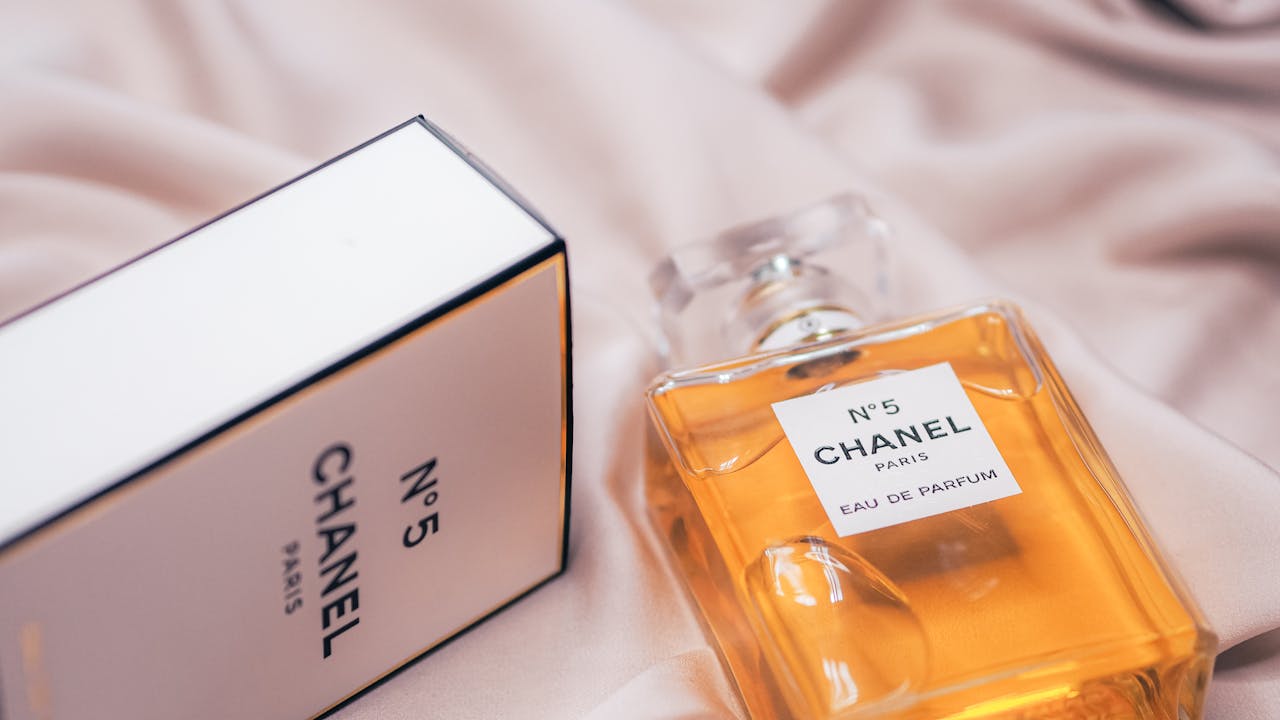 Crafting Captivating Headlines: Your awesome post title goes here Close-up of Chanel No.5 perfume bottle and box on a soft fabric in Paris.