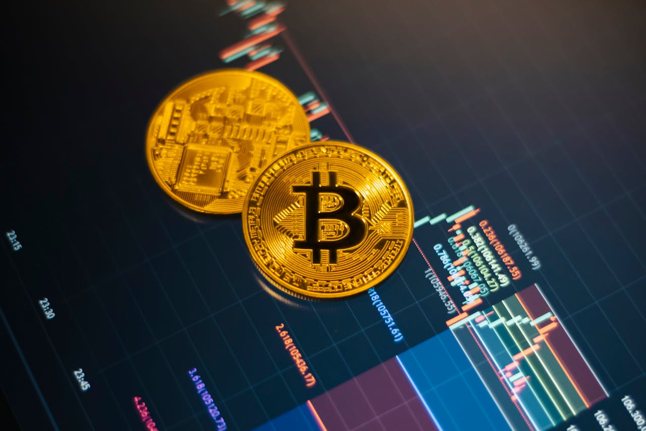 Golden Bitcoin coins on a digital stock market chart showcasing cryptocurrency trading.