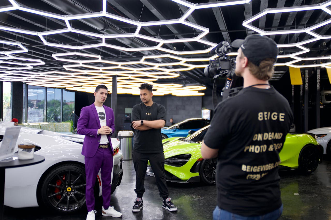 vision Behind-the-scenes filming of luxury cars in a Los Angeles showroom, showcasing high-end automotive video production.