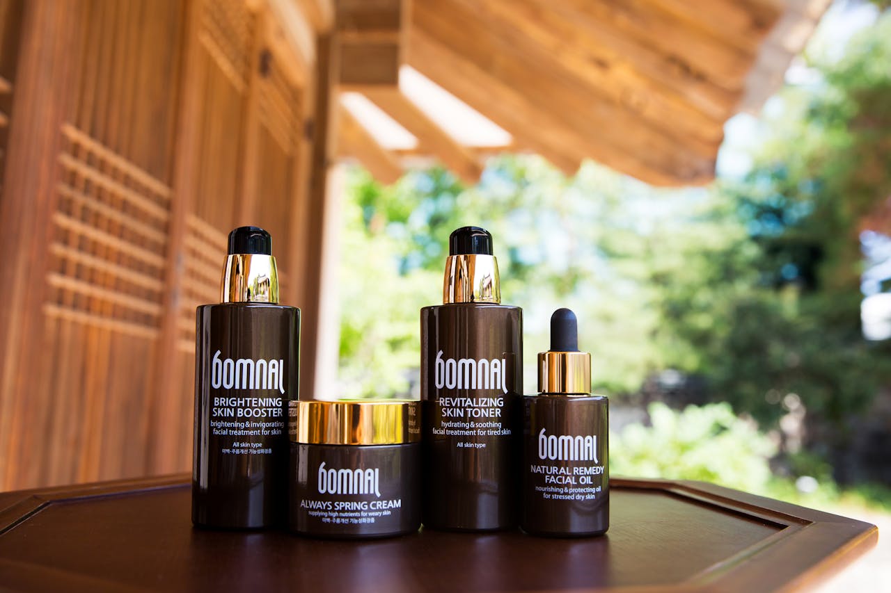 journey-01 Elegant Bomnal skincare set displayed on a wooden table with natural outdoor background.