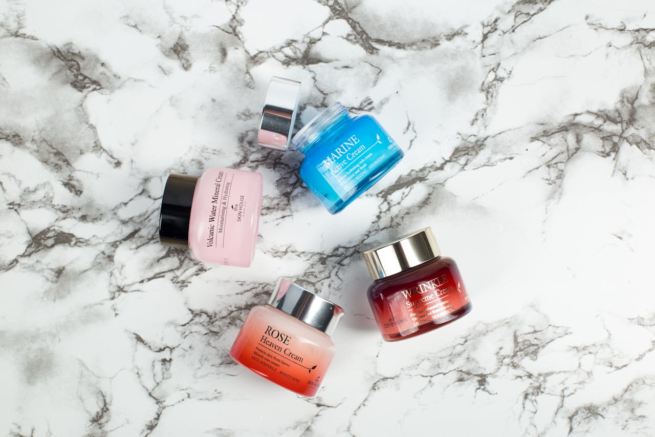 The Art of Drawing Readers In: Your attractive post title goes here Flatlay of elegant skincare creams on marble showcasing vibrant colors and luxurious packaging.